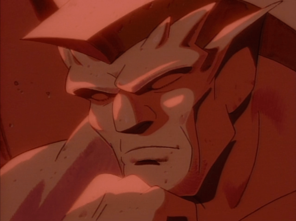 A close-up of Goliath from "Gargoyles" in his stone form, posing like Rodin's Thinker.