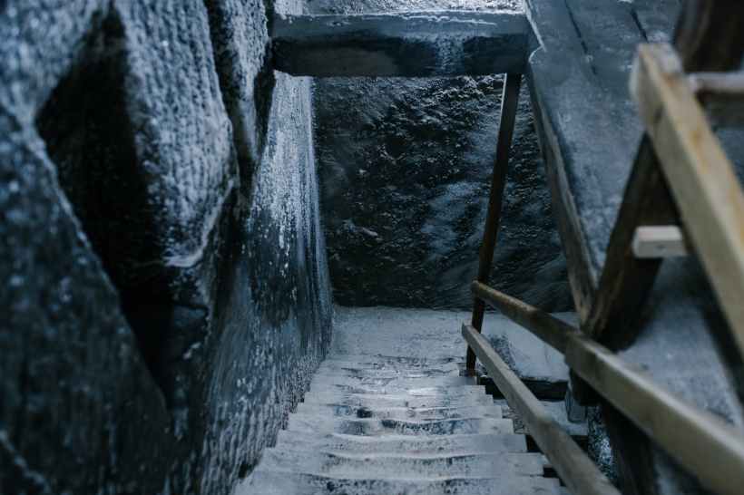 Looking down a flight of stairs in an old mine. Photo by Julia Volk on pexels.com