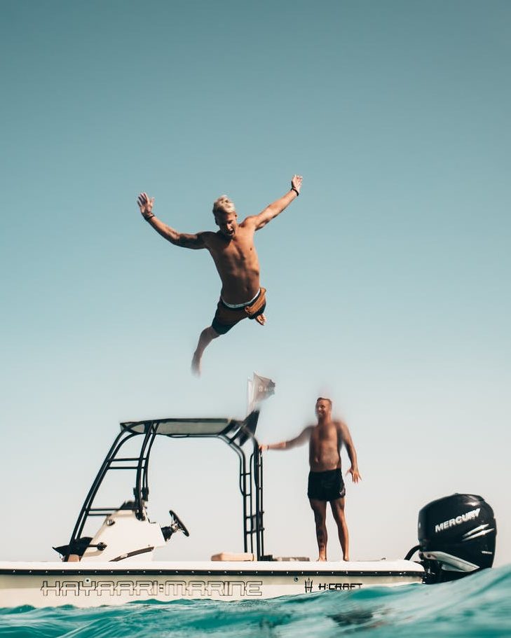 A man about to belly-flop in the water.