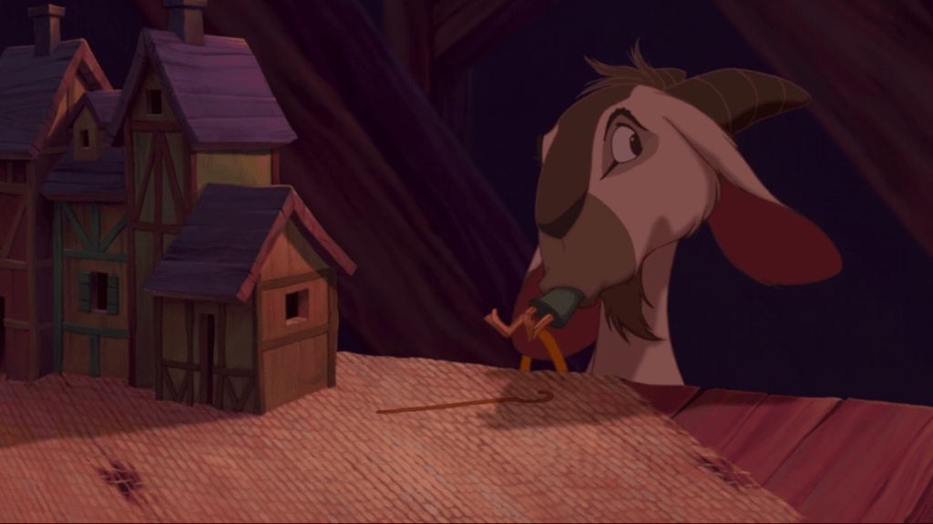 A scene from "The Hunchback of Notre Dame". Djali the goat eating a wooden figurine.