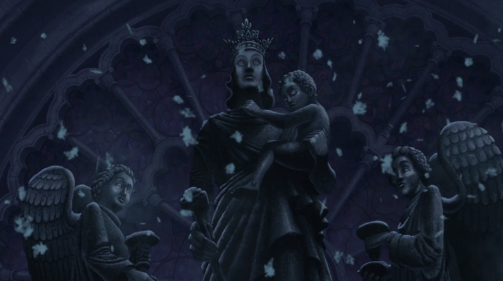 A scene from "The Hunchback of Notre Dame", the statue of the Virgin Mary holding the child Jesus, flanked by angels at the top of the church.