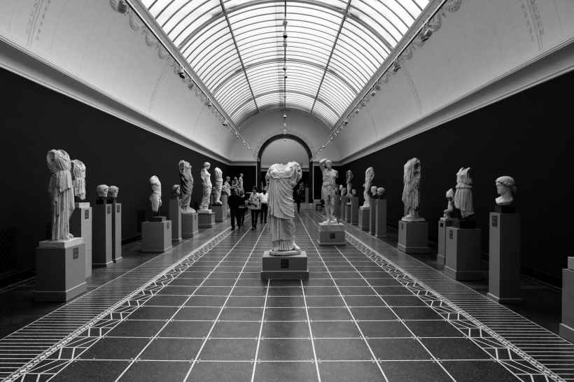 A gallery of Antique statues in a museum.