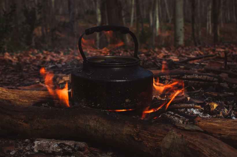 A kettle over a campfire.