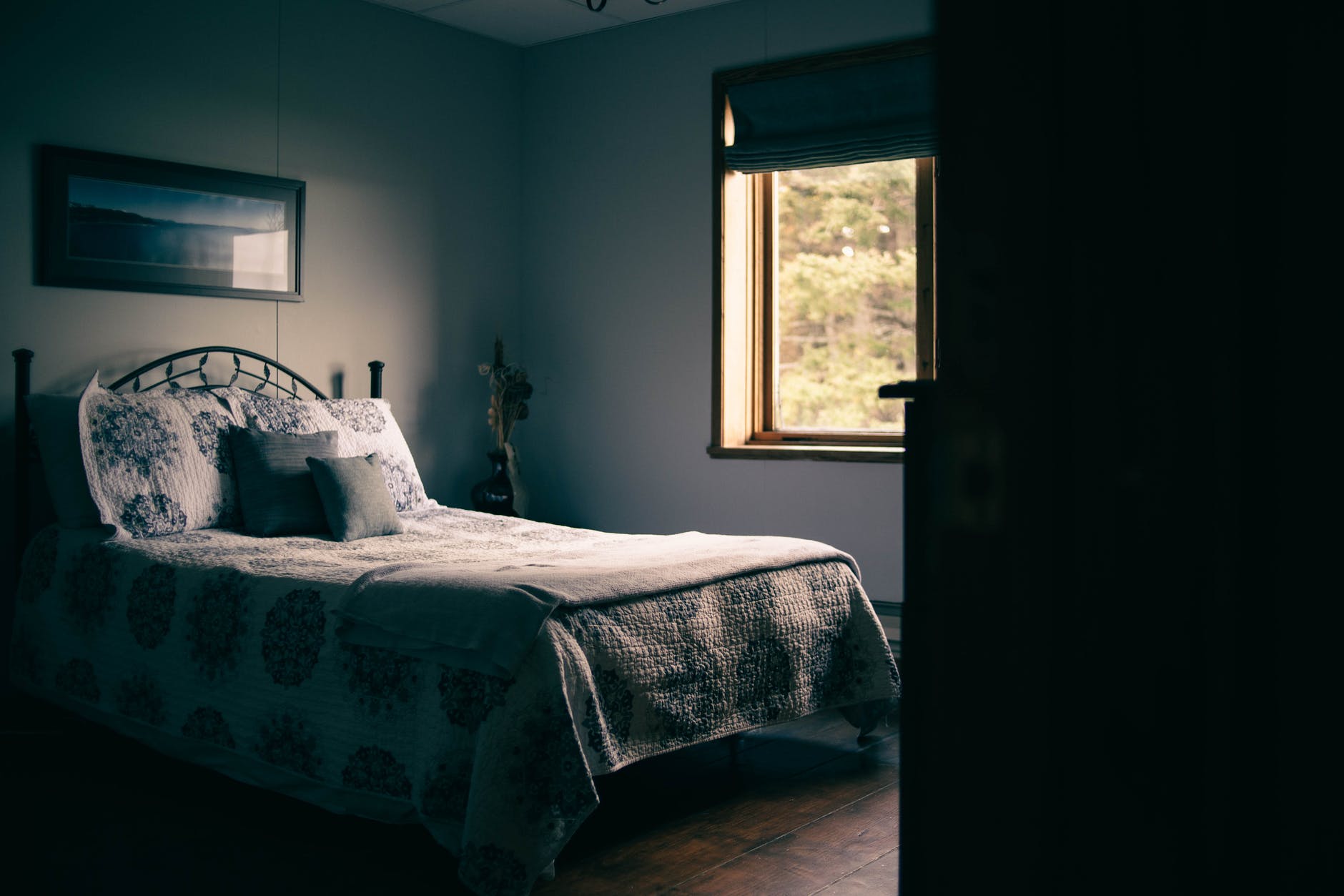 A bedroom illuminated by natural light coming through the window.