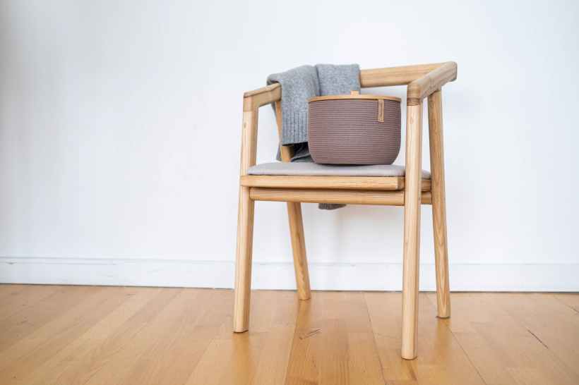 A basket on a wooden chair.