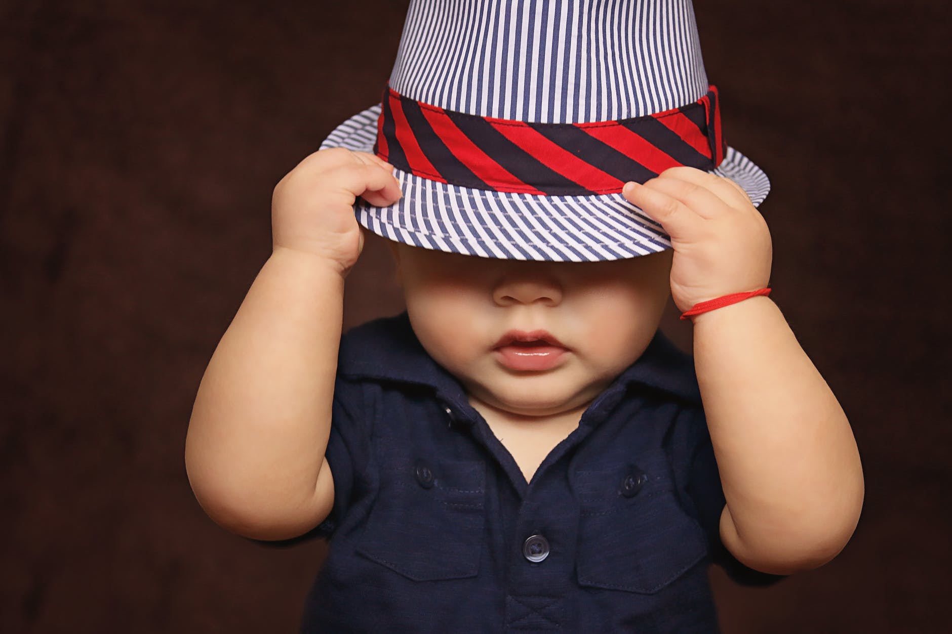 A baby boy in a rather fashionable hat.