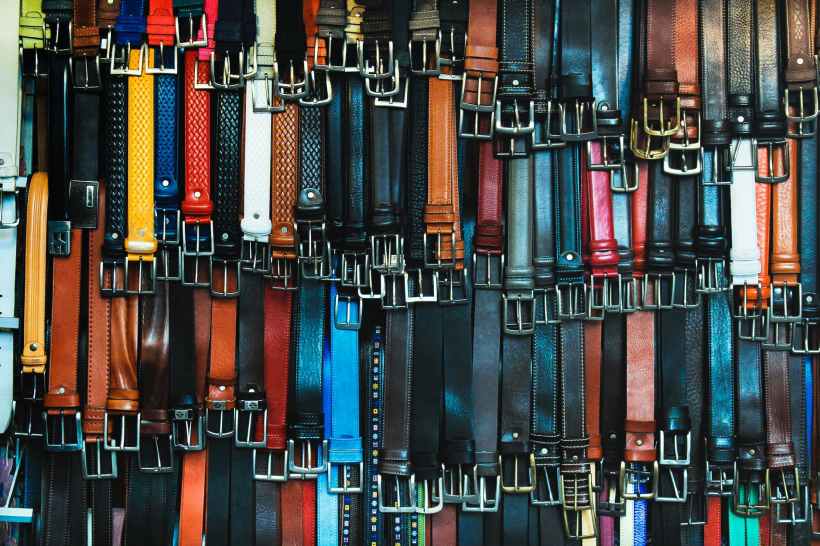 A rack of numerous belts.