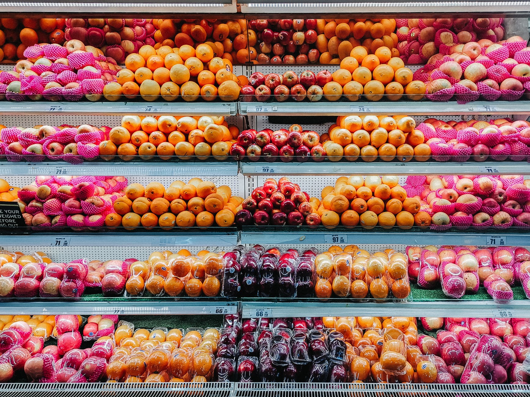 Shelves of fruit at a grocery store.
