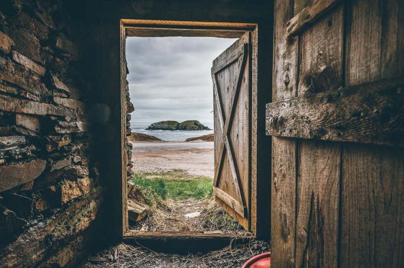 A door open to a beach.