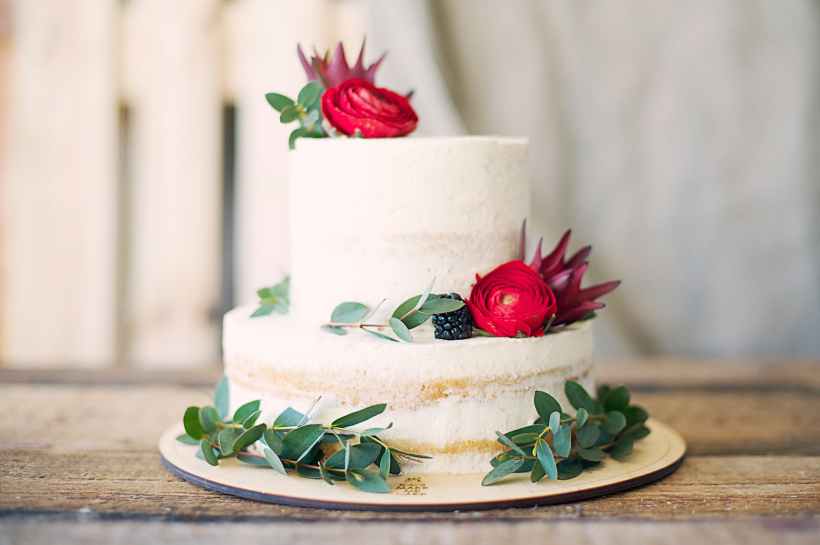 A white cake with decorative flowers.