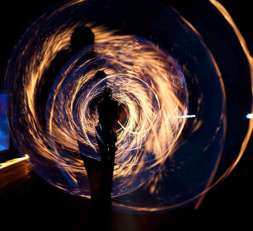 Several concentric versions of a person making a circle with a sparkler.
