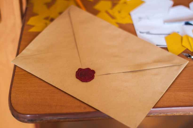 A letter with a wax seal on a table.