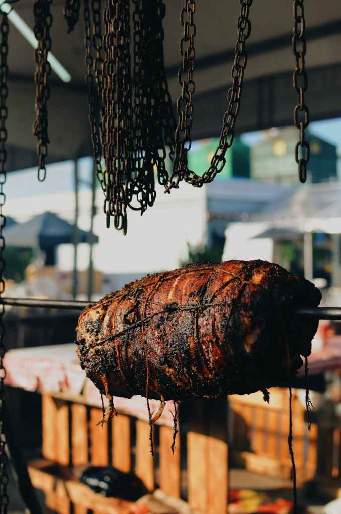 A hunk of meat roasting on a spit.