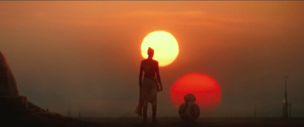 A scene from "Rise of Skywalker." Rey and BB-8 watching the sunset on Tatooine.