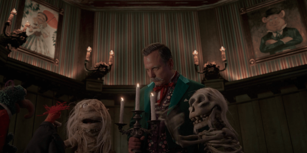 A scene from "Muppets Haunted Mansion" with Will Arnett and some Muppets.