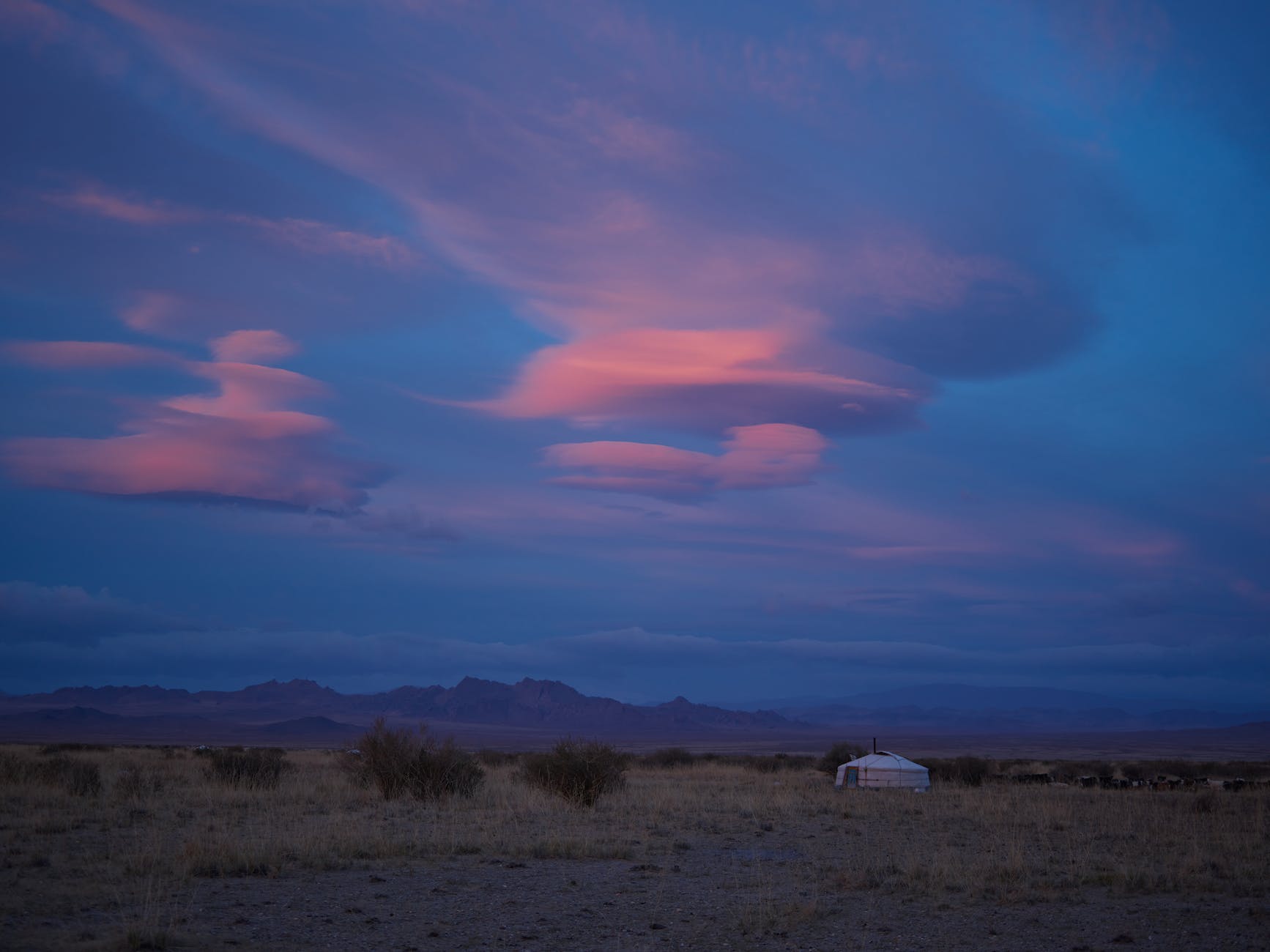 A yurt under the sky at twilight.