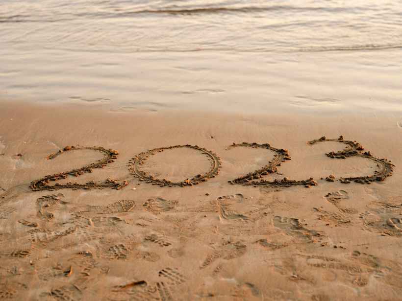 "2023" written on a beach.
