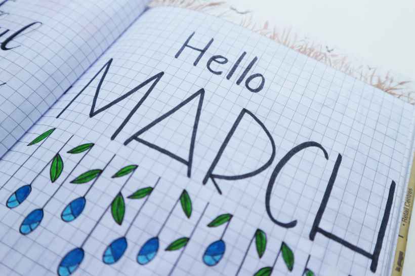 Graph paper with a drawing of flowers that says "Hello March."