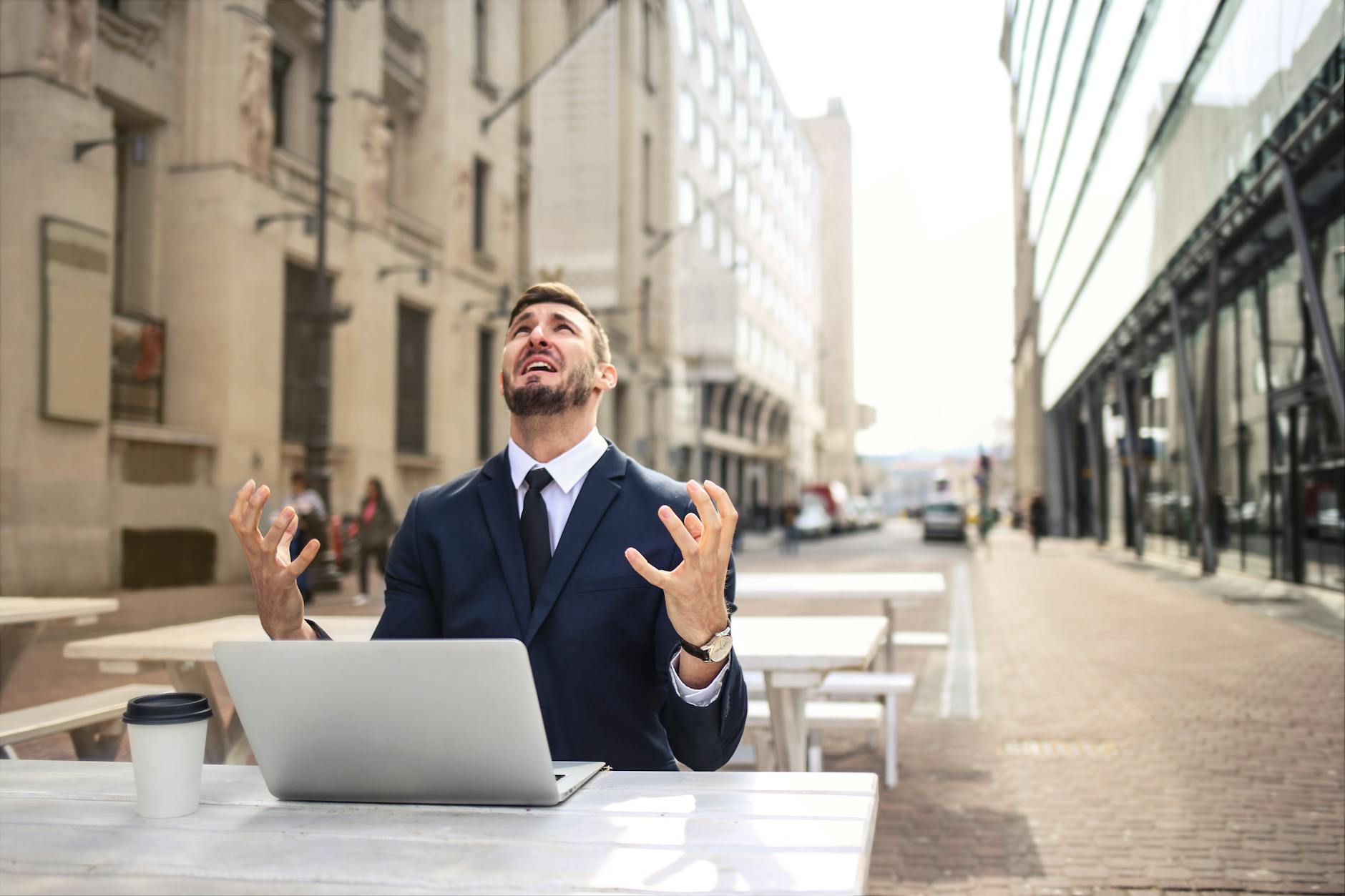 A man reacting in despair to his computer.