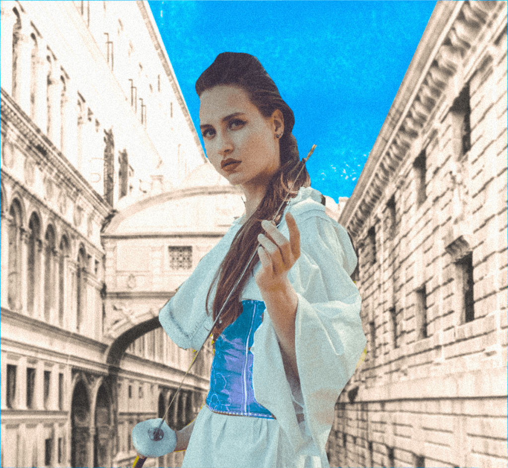 A woman with a fencing foil in front of Venice's Bridge of Sighs.
