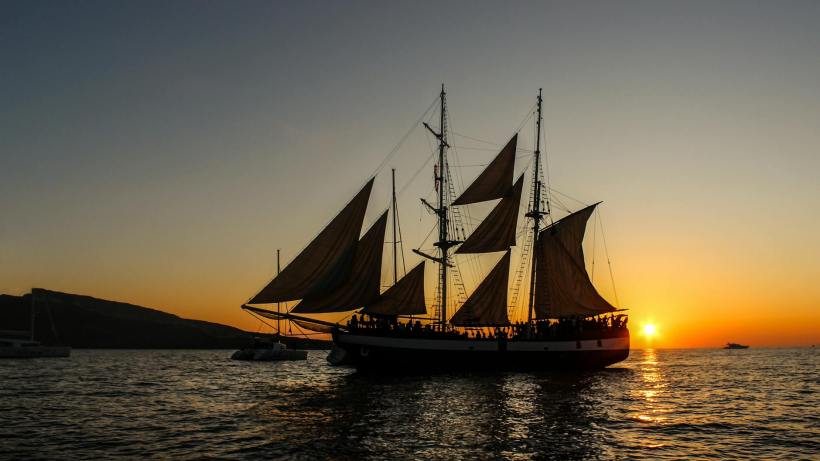 A pirate ship silhouetted by the sunset.