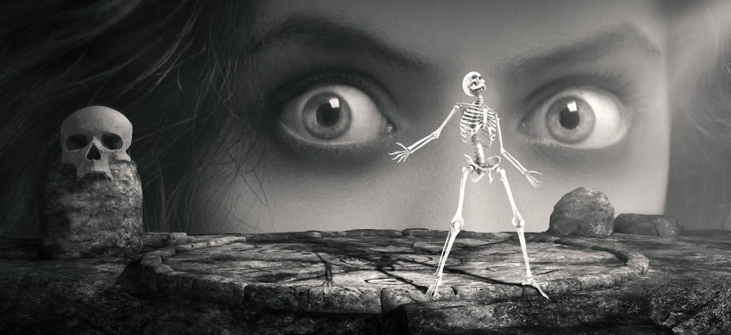 A woman looking at a tiny skeleton.