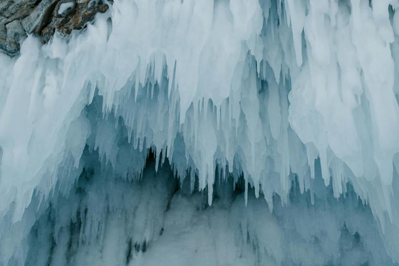 Icicles growing from a stone overhang.