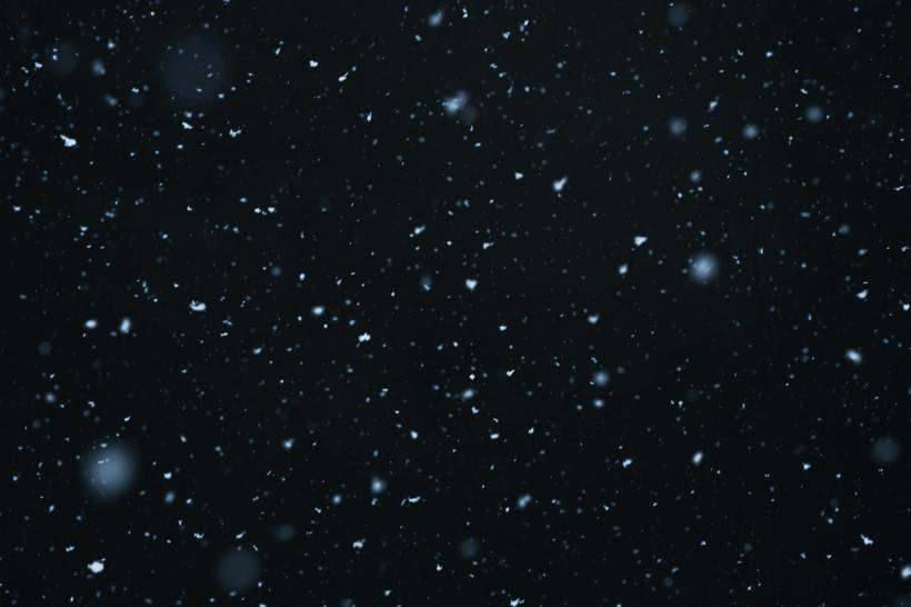 Snow falling against a black background.