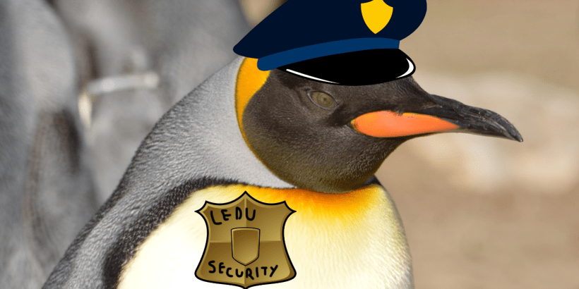 A penguin wearing a police hat and badge.