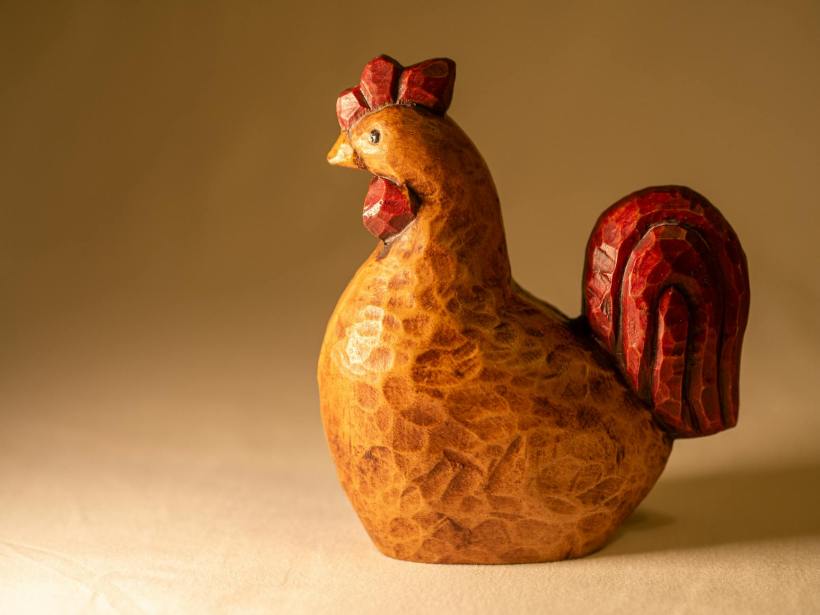 A pottery chicken sculpture.
