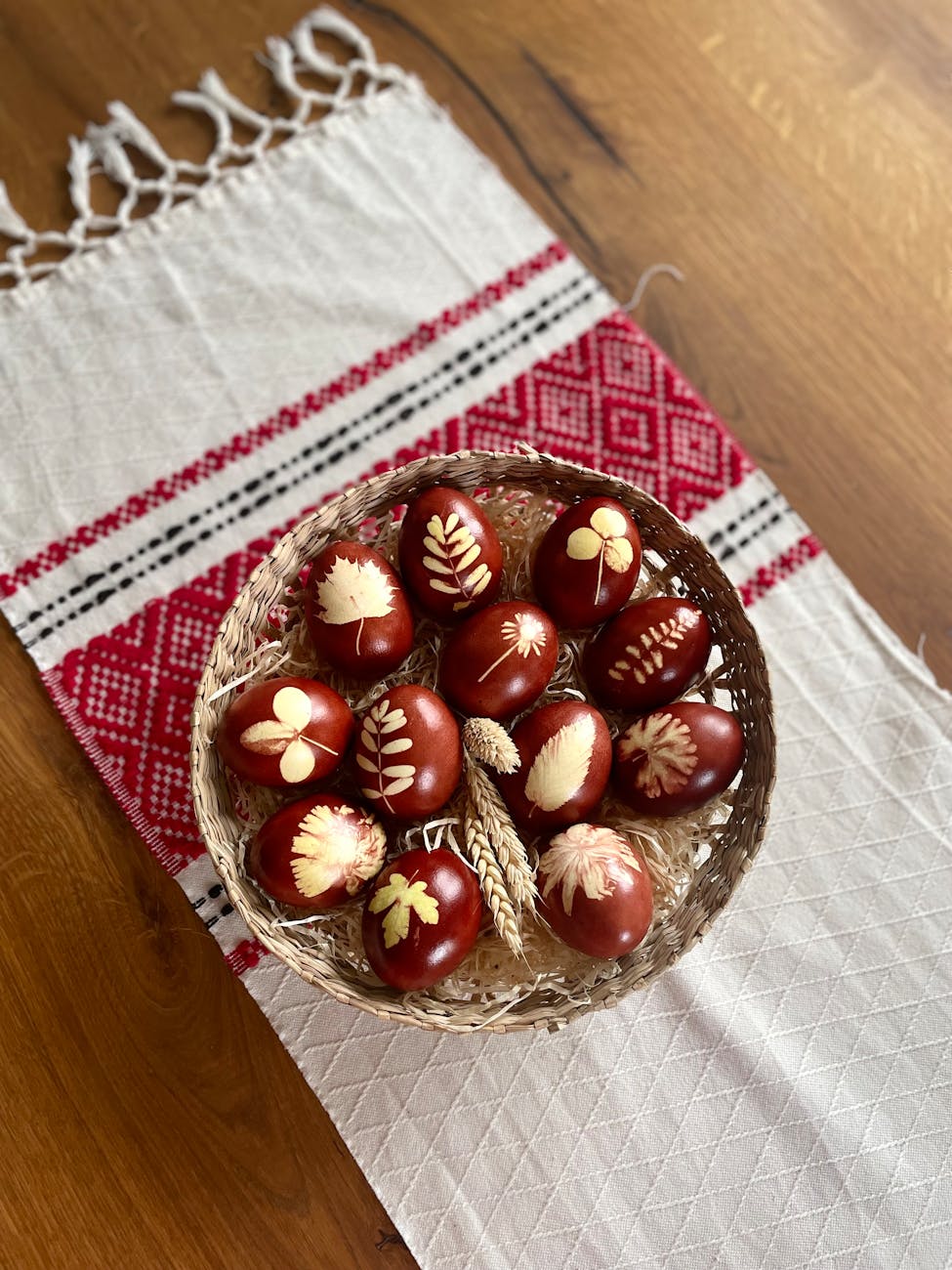 A basket of eggs on a tablecloth.