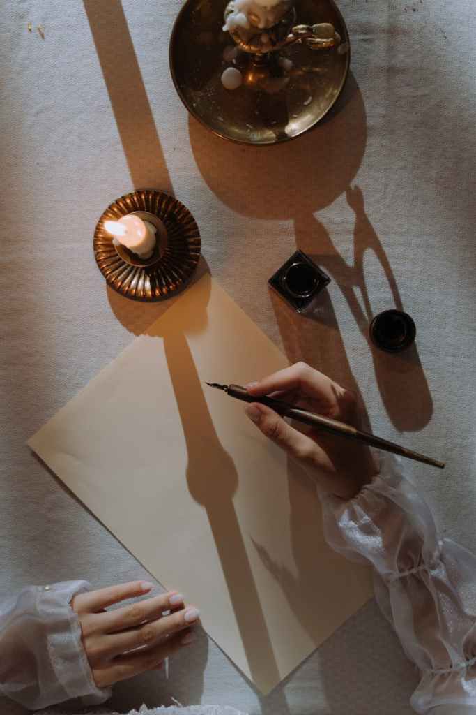 A hand writing with a quill.