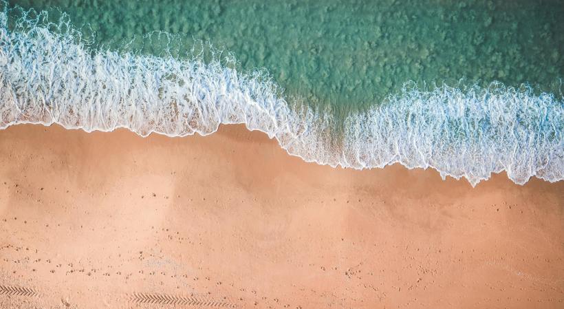 Waves on the beach from above.