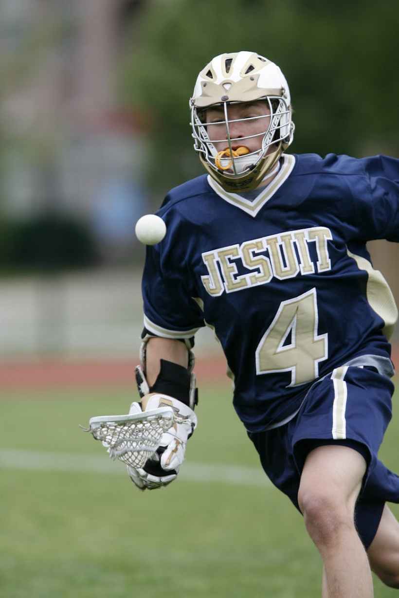 A lacrosse player with 4 on his jersey.