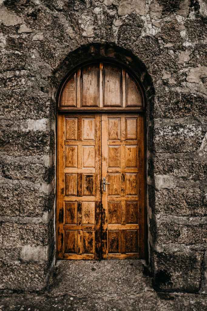 A wooden door in a stone wall.