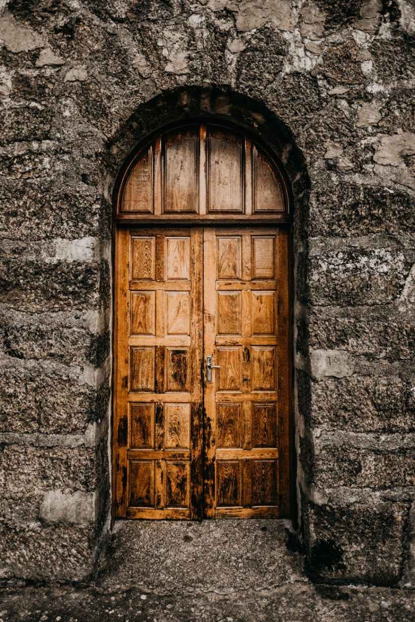 A wooden door in a stone wall.