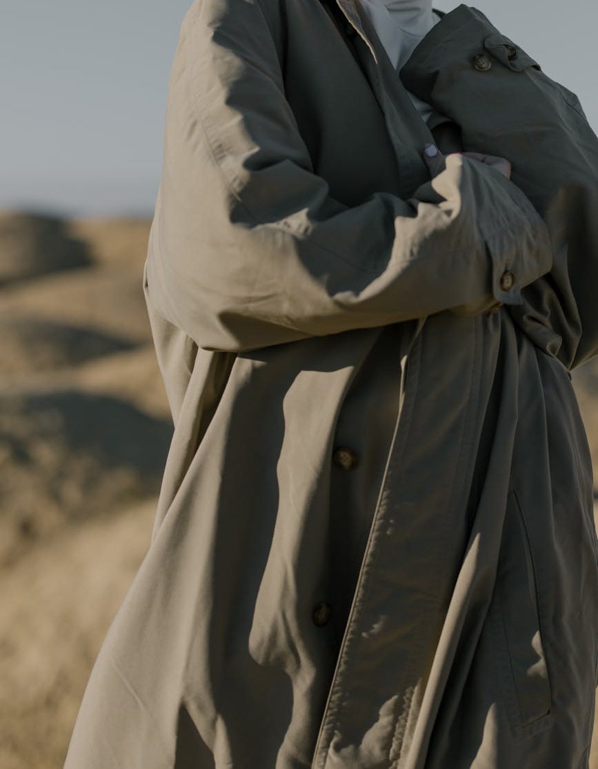 A close-up of a person in a trenchcoat.