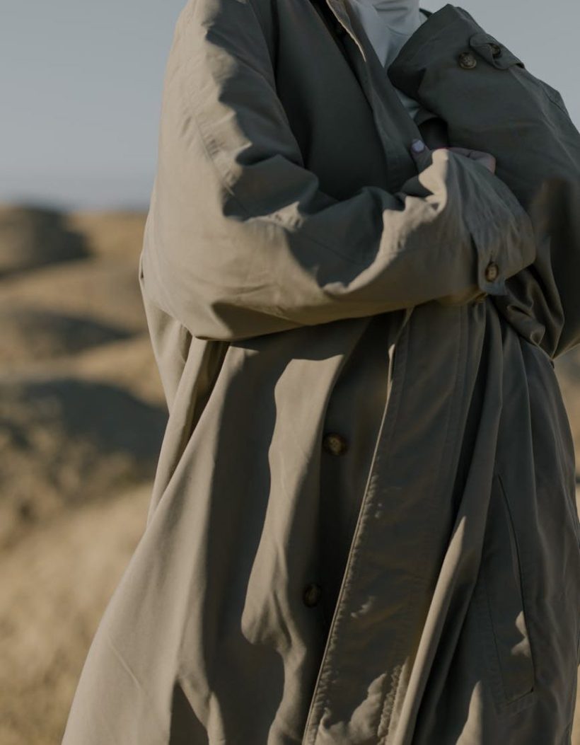 A close-up of a person in a trenchcoat.