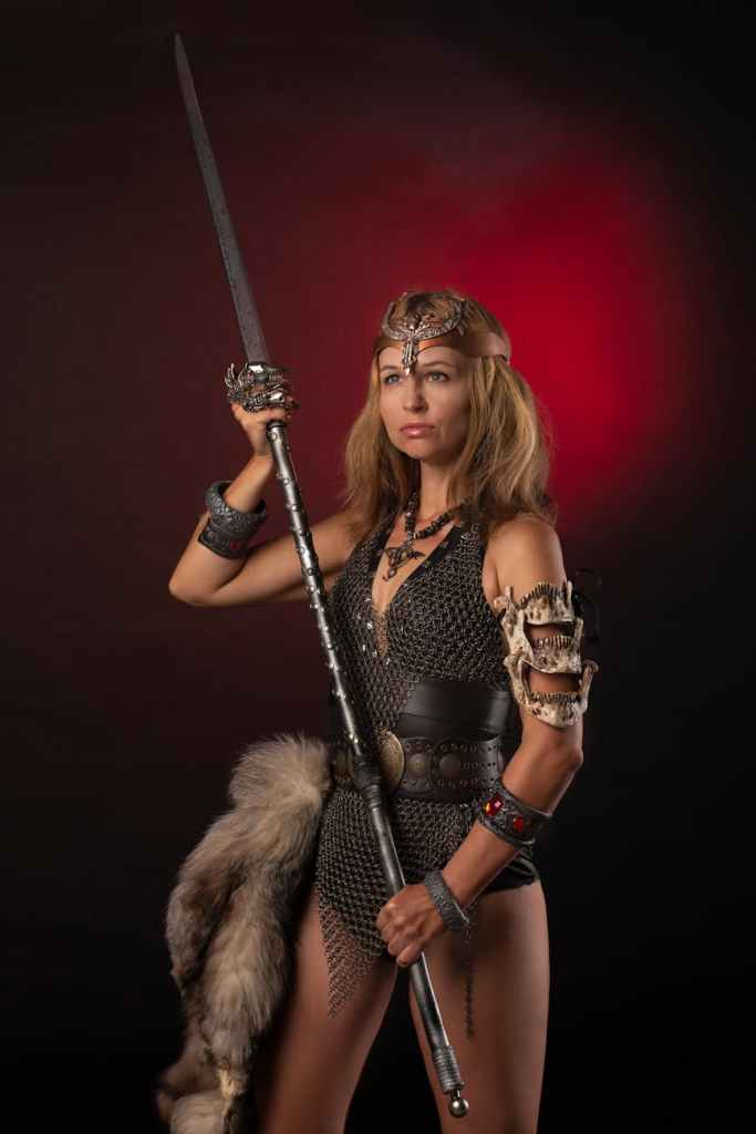 A woman with a spear in chainmail armour.