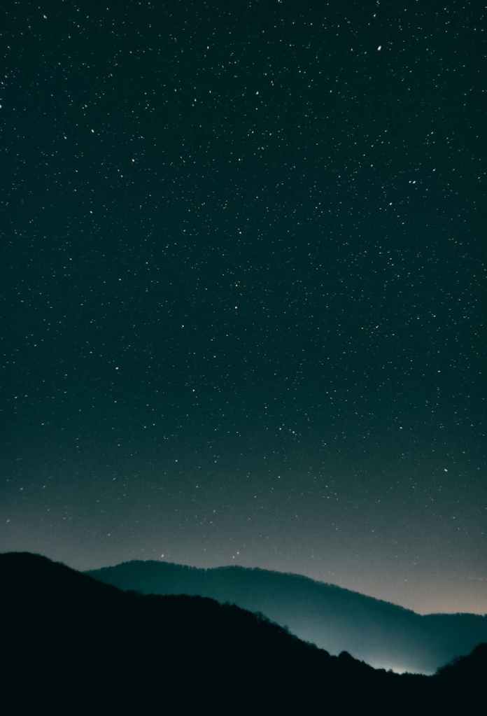 The night sky and a hill.