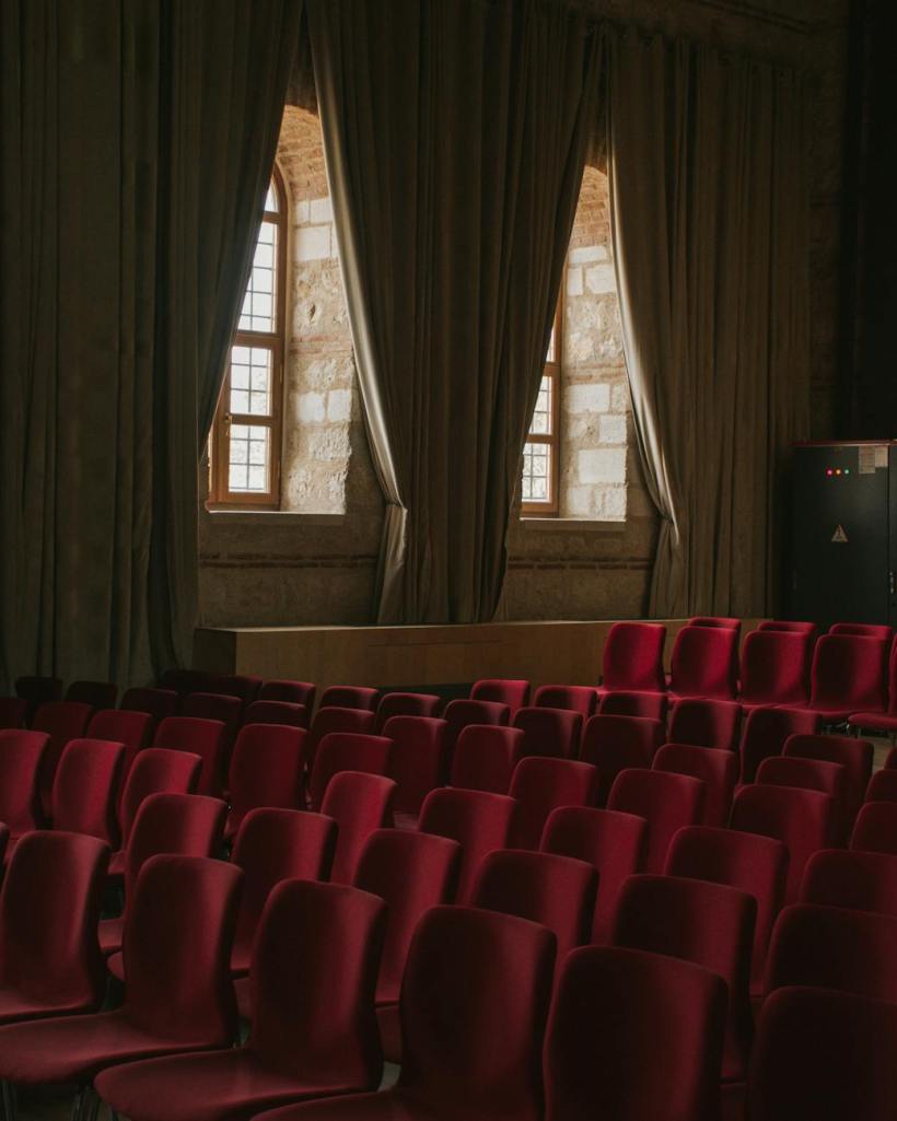 Windows and seats in an auditorium.