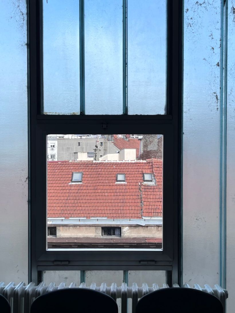 A window overlooking the roof of another building.
