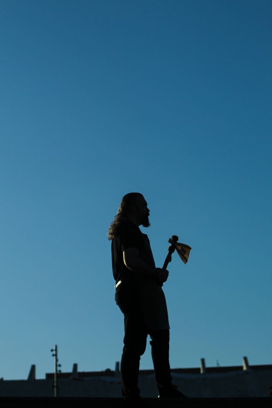 A silhouette of a person with an axe.