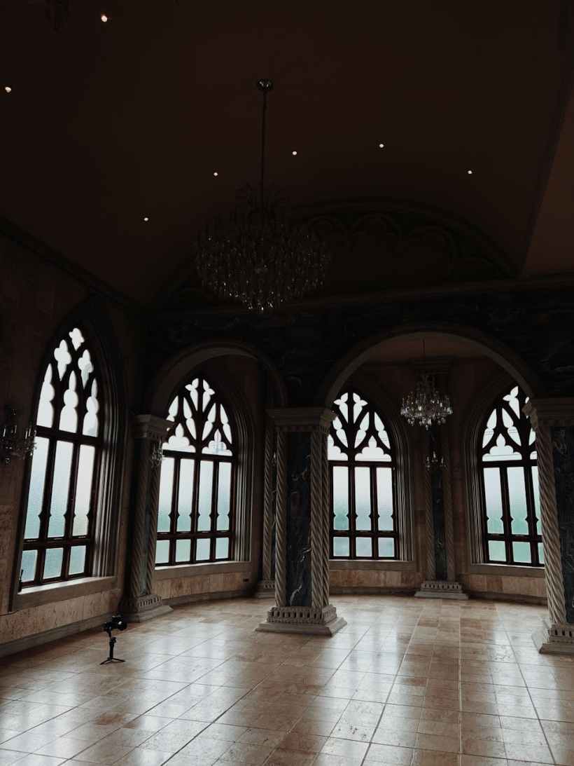 A room in a castle with large, ornate windows.