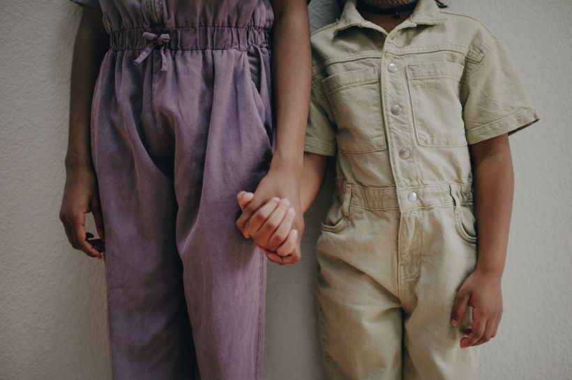 Two kids holding hands.